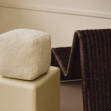 Load image into Gallery viewer, Lifestyle abstract shot of cream wool bouclé cube cushion on plinth