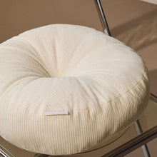 Load image into Gallery viewer, Lifestyle close up shot of cream cotton corduroy round cushion on chair