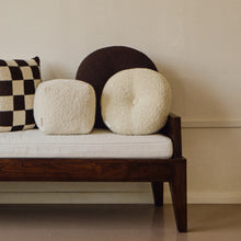Load image into Gallery viewer, Lifestyle shot of brown wool bouclé round cushion with other cushions on daybed
