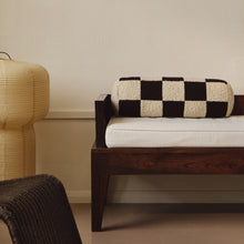 Load image into Gallery viewer, Lifestyle shot of cream and brown wool bouclé checkered bolster cushion on daybed
