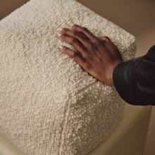 Load image into Gallery viewer, Lifestyle shot of hand resting on cream wool bouclé cube cushion
