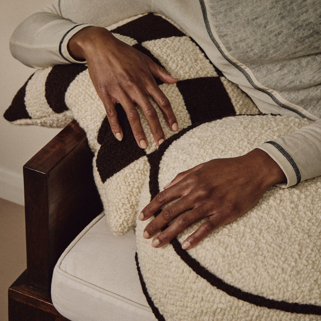 Cream wool bouclé round piped cushion on daybed - handmade in UK